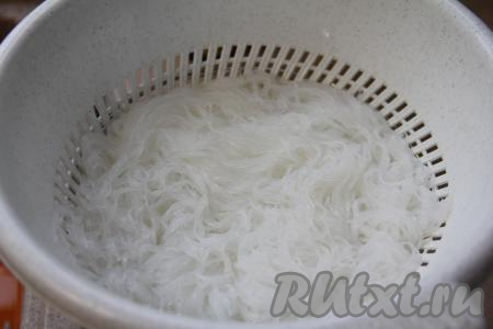 По прошествии 5 минут откинуть фунчозу на дуршлаг, промыть её холодной водой, оставить на несколько минут, чтобы стекла лишняя вода. Затем нарезать фунчозу ножницами на части.