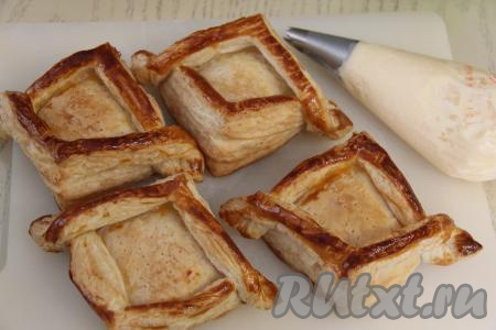 Выпекать слойки в разогретой духовке при температуре 220 градусов минут 10, затем убавить огонь до 200 градусов и выпекать ещё минут 10. Затем достать слойки из духовки и полностью их остудить. Крем переложить в кулинарный мешок с фигурной насадкой.