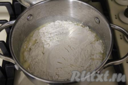 Довести смесь воды и масла до кипения, затем уменьшить огонь до минимума и всыпать в кастрюлю муку.&nbsp;