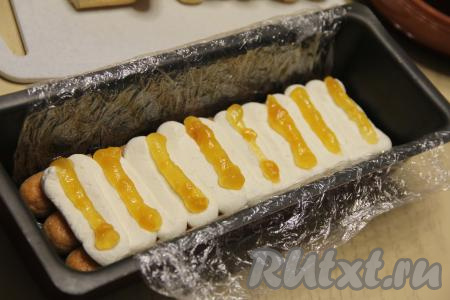 Половину ягодного пюре (или джема) выложить поверх крема в виде полосок. В качестве ягодного пюре я использовала манго, протёртое с сахаром.