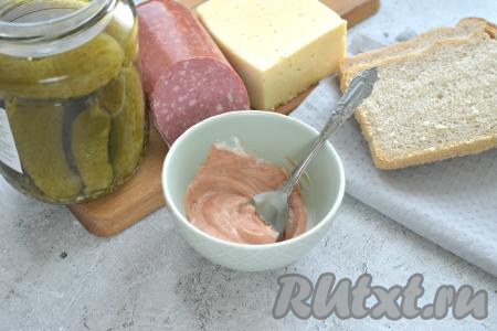 Подготовим продукты для приготовления бутербродов "Мини-пицца" в духовке. В маленькую миску кладём томатный соус (или кетчуп), добавляем майонез, хорошо перемешиваем.&nbsp;