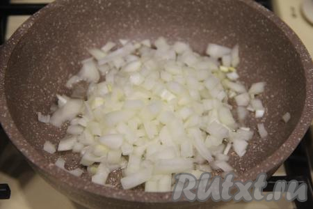 Прогреть растительное масло в сковороде, выложить лук и обжарить его на среднем огне в течение 3-4 минут (до золотистого цвета), время от времени перемешивая.