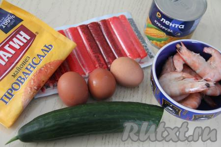 Подготовить продукты для приготовления салата с креветками, яйцом и крабовыми палочками. Креветки разморозить. Крабовые палочки, если они заморожены, нужно разморозить. Вымыть свежий огурец. Сварить вкрутую яйца (в течение 10 минут после закипания воды), полностью остудить их и очистить.