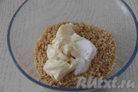 Бисквитную крошку всыпать в миску, добавить мягкое сливочное масло и сгущёнку.