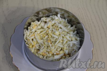 Смазать ананасы тонким слоем майонеза. Следующим слоем выложить яйца, натёртые на крупной тёрке.