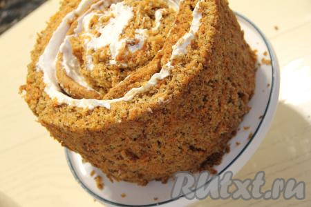 Свернуть первую полоску бисквита с кремом, начиная с узкой стороны, в рулетик, поставить этот рулетик срезом вверх на плоскую тарелку (или на подставку для торта). Вторую полоску бисквита с кремом обернуть вокруг рулетика, стоящего на тарелке. Третью полоску бисквита с кремом обернуть вокруг второй полоски. У нас получится торт-улитка, как на фото.