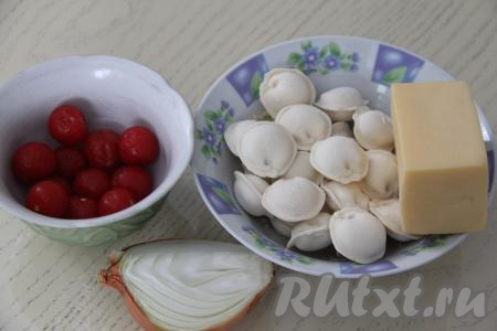 Подготовить продукты для приготовления жареных пельменей с помидорами и сыром. Для этого блюда нам потребуются замороженные домашние или покупные пельмени. Лук почистить. Помыть помидоры и лук.