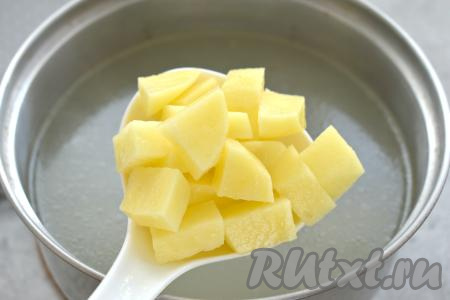 В кастрюлю с закипевшим бульоном выкладываем очищенную картошку, нарезанную на средние кубики, снова даём закипеть и варим 5 минут на небольшом огне.