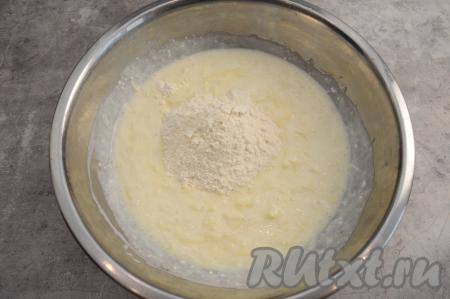 В творожно-яблочную массу всыпать половину муки, хорошо перемешать лопаткой тесто для оладий.