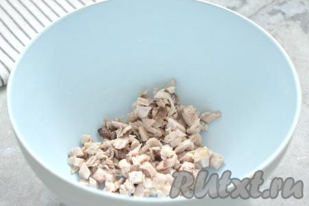 Заранее отвариваем куриное мясо в подсоленной воде в течение 30 минут после закипания. Затем даём мясу остыть. 70 грамм мяса курицы нарезаем на маленькие кусочки, перекладываем в миску.