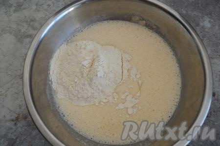 Затем соединить подошедшую опару и взбитые яйца, перемешать венчиком до однородности и начать постепенно добавлять муку.