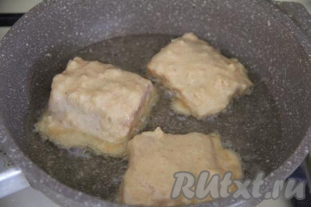 В сковороду влить растительное масло, разогреть его, выложить в один слой кусочки горбуши, покрытые луковым кляром. 