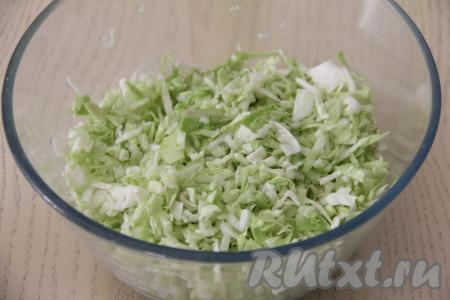 Свежую молодую (или остывшую обжаренную) капусту выложить в глубокую миску.&nbsp;