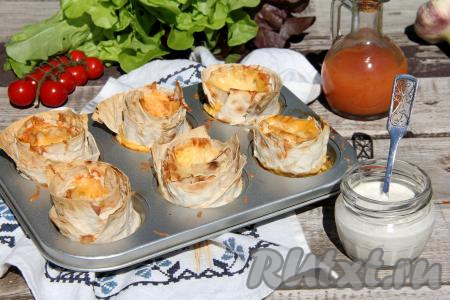 Порционные омлеты с сыром, приготовленные в лаваше, достать из духовки и в горячем виде подать к столу. Хотя и после остывания эти рулетики из лаваша, запечённые с яйцом, колбасой и сыром, хороши на вкус.