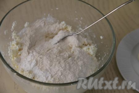 В миске соединить творог (у меня был творог жирностью 9%) и сырые яйца. Перемешать вилкой творожно-яичную массу до однородности. Затем всыпать соль, разрыхлитель и половину муки.&nbsp;
