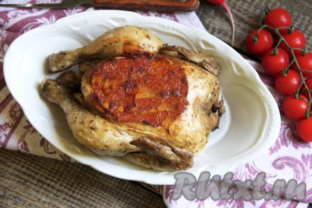 Готовую курицу, запечённую целиком в мультиварке, переложить с фольги на блюдо и подать к столу.