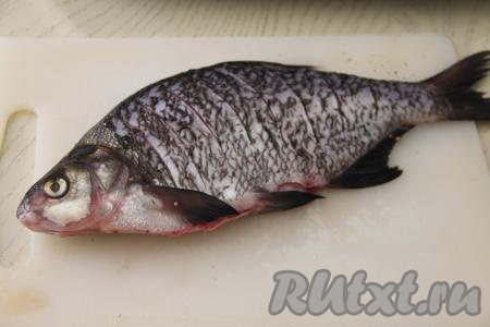 Леща почистить от чешуи. Удалить внутренности, промыть рыбу под проточной водой, затем немного обсушить. Сделать надрезы острым ножом с двух сторон по всей поверхности леща. Надрезы позволяют лучше запечься рыбке и размягчают тонкие косточки, которых в леще много.