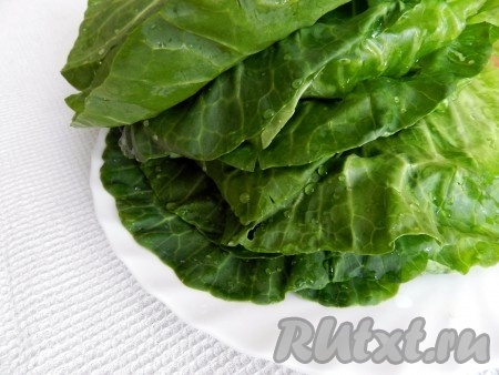 Рис промыть, выложить в кастрюлю с достаточно большим количеством кипящей воды, дать закипеть, перемешать, варить минут 15-20 (до готовности риса), затем выложить в дуршлаг, дать стечь воде и полностью остудить. Для приготовления голубцов понадобится 0,5 стакана отваренного риса. Листья капусты отделить от кочана, тщательно промыть их.