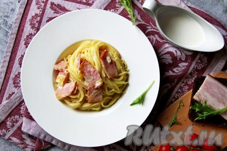 Аппетитные спагетти, покрытые&nbsp;соусом из бекона и сливок,&nbsp;разложить со сковороды по тарелкам и подать в горячем виде вкусное, насыщенное блюдо к столу.