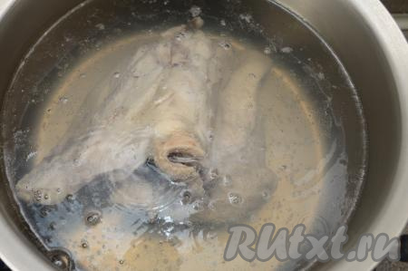 Выкладываем вымытые части курицы в кастрюлю, заливаем 2 литрами воды, ставим на сильный огонь. После закипания бульона убираем с поверхности пену и варим куриное мясо минут 25-30 на небольшом огне. Затем снимаем кастрюлю с огня, достаём мясо, выкладываем курицу на тарелку, чтобы она немного остыла. Бульон при необходимости процеживаем, возвращаем в кастрюлю и ставим на огонь.