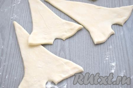 У основания каждого треугольника из теста делаем небольшой надрез, а углы разводим немного в сторону.