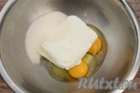 В отдельную миску выложить творог, добавить сахар и сырые яйца.