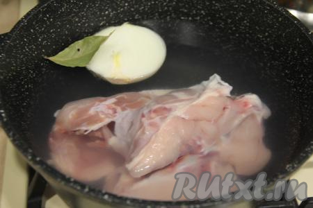 Части курицы (у меня - суповой набор) вымыть, выложить в кастрюлю, влить 2 литра, добавить половину очищенной луковицы и лавровый лист.