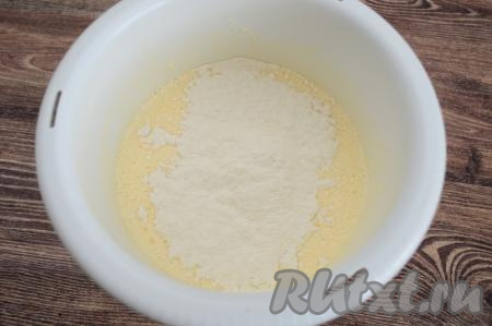 Сразу добавить примерно треть всей просеянной муки, перемешать лопаткой, распределяя муку по всему тесту и полностью вмешивая её.