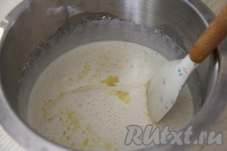 Сливочное масло растопить до жидкого состояния (удобно растапливать масло в микроволновке), дать немного остыть. В чашу миксера с яичной массой влить растопленное не горячее масло и ряженку, перемешать массу лопаткой до однородности.