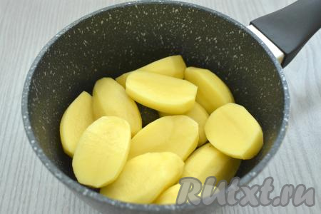 Слоёное тесто (я купила дрожжевое слоёное тесто, можно взять и бездрожжевое) достаём из морозилки и оставляем размораживаться при комнатной температуре до мягкости. За это время приготовим начинку для пирожков. Для этого выкладываем в кастрюлю&nbsp;очищенную картошку (крупные картошины можно предварительно разрезать на 2-4 части), заливаем полностью водой, ставим на сильный огонь. После того как вода в кастрюле закипит, уменьшаем огонь, добавляем соль и отвариваем картофель до готовности. Обычно на варку требуется минут 20-25, картошины должны стать достаточно мягкими и легко прокалываться вилкой.