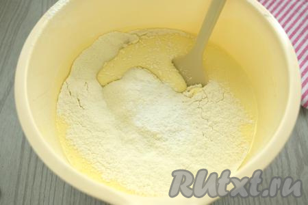 Во взбитую яичную массу всыпаем разрыхлитель и грамм 70 просеянной муки, перемешиваем бисквитное тесто лопаткой (или столовой ложкой), полностью вмешивая муку, но при этом стараясь не сбить воздушность взбитых яиц. 