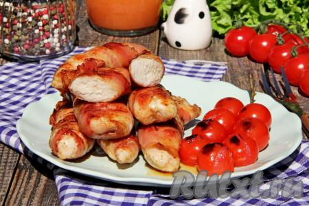 Нежные, сочные кусочки куриного мяса, жареные в беконе, к столу подать в горячем виде, дополнив соусом, салатом из свежих овощей или гарниром на ваш выбор.&nbsp;