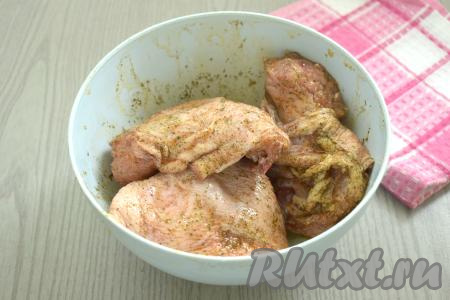 Куриные бёдра выкладываем в миску, добавляем получившуюся смесь масла и специй, тщательно перемешиваем, втирая масло со специями в мясо со всех сторон. Оставляем бёдрышки промариноваться на 15 минут при комнатной температуре.