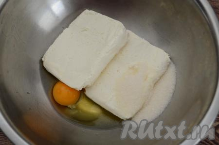 В миску выложить творог, сахар и сырое яйцо.