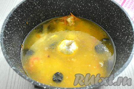 Рис заливаем 400 миллилитрами тёплой воды, добавляем подготовленный чернослив, а в центр ставим целую головку чеснока.