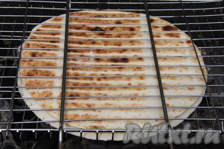 Жарить тортильи, между которыми находится сыр, до золотистого цвета с двух сторон (ориентировочно по 3 минуты с каждой стороны). Затем переложить на тарелку для подачи. Аналогично между двумя оставшимися лепёшками выложить оставшийся сыр и тоже пожарить на решётке на мангале до золотистости.