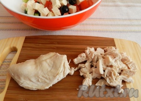 Оливки разрезать пополам. Нарезать куриное мясо кубиками.
