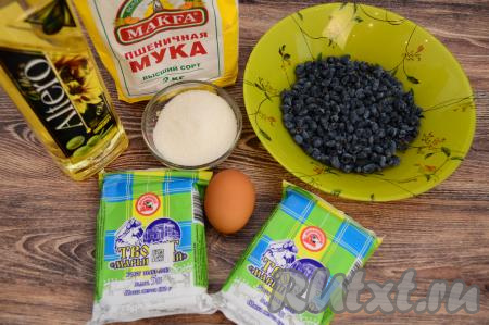 Подготовить продукты для приготовления сырников с жимолостью. Жимолость можно взять как свежую, так и замороженную. Свежие ягоды нужно перебрать, промыть, а затем обсушить, разложив ягодки на бумажном полотенце. Замороженную жимолость, если на ней нет большого количества наледи, можно не размораживать. Для приготовления сырников лучше всего подходит творог жирностью не менее 5%.