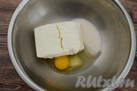 В миску высыпать сахар, выложить творог, вбить сырое&nbsp;яйцо.