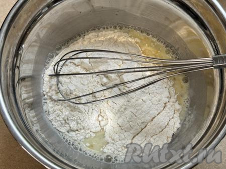 В миску с молочной-яичной смесью частями добавить муку, каждый раз перемешивая кляр венчиком до однородности.&nbsp;