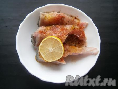 Кусочки рыбки посолить, приправить специями (в качестве специй я добавила&nbsp;0,5 чайной ложки чесночного перца,&nbsp;0,5 чайной ложки молотой паприки и&nbsp;1/4 чайной ложки порошка карри), добавить лимонный сок, перемешать, чтобы специи равномерно распределились по толстолобику.