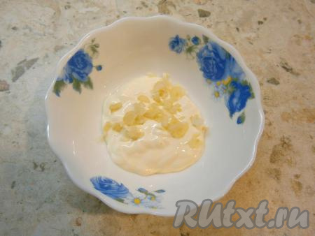 В майонез добавить мелко нарезанный чеснок, перемешать.