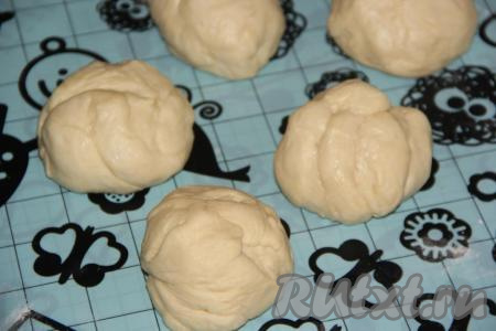 Пока тесто поднимается, достать из холодильника 50-60 грамм масла, которое будет использоваться для смазывания теста при формировании краффинов, дать ему согреться при комнатной температуре и стать мягким, это масло в дальнейшем будем использовать для смазывания теста. Поднявшееся тесто переложить на стол, присыпанный мукой, обмять, разделить на 5 равных частей.