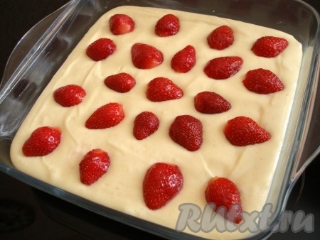 Форму для выпечки размером 20 сантиметров на 20 сантиметров смазать маслом, вылить в неё тесто, распределить равномерно. Выложить ягоды клубники, слегка вдавливая их в тесто. Выпекать клубничный пирог в разогретой до 190 градусов духовке минут 35-40. Готовность проверьте, проколов тесто сухой деревянной шпажкой (если шпажка и после прокола теста останется сухой, значит пришло время доставать выпечку из духовки).