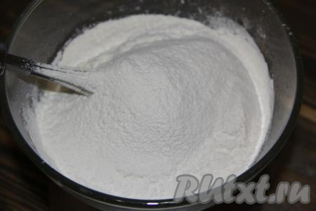 Затем всыпать соль и начать постепенно подсыпать просеянную муку, каждый раз полностью вмешивая её. Тесто вначале перемешивать столовой ложкой.