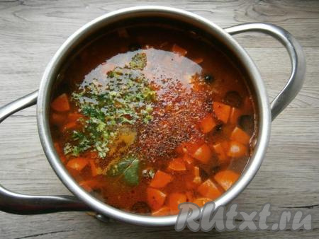 Далее добавить в кастрюлю измельченный чеснок, всыпать паприку, специи и мелко нарезанную зелень, проварить солянку еще минут 5-7, выключить газ.