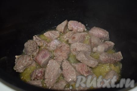 Доводим масло до кипения и выкладываем в чашу мясо, солим по вкусу. Обжариваем кусочки говядины со всех сторон, не закрывая крышку мультиварки, примерно, 15 минут (до подрумянивания).