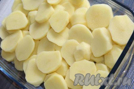 Нарезать картофель кружочками толщиной 0,5 см. Выложить картошку в жаропрочную форму. Дно формы можно не смазывать маслом.