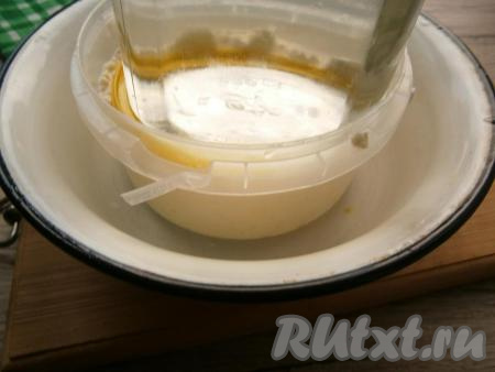 Подставить под контейнер миску, сверху творога установить гнет. Выдержать сыр под гнетом в прохладном месте часов 5.