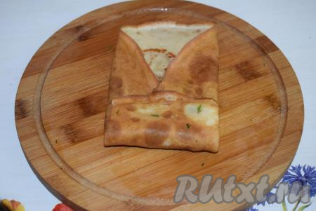 Затем накрываем горку с начинкой оставшимся свободным концом блинчика с одной стороны.